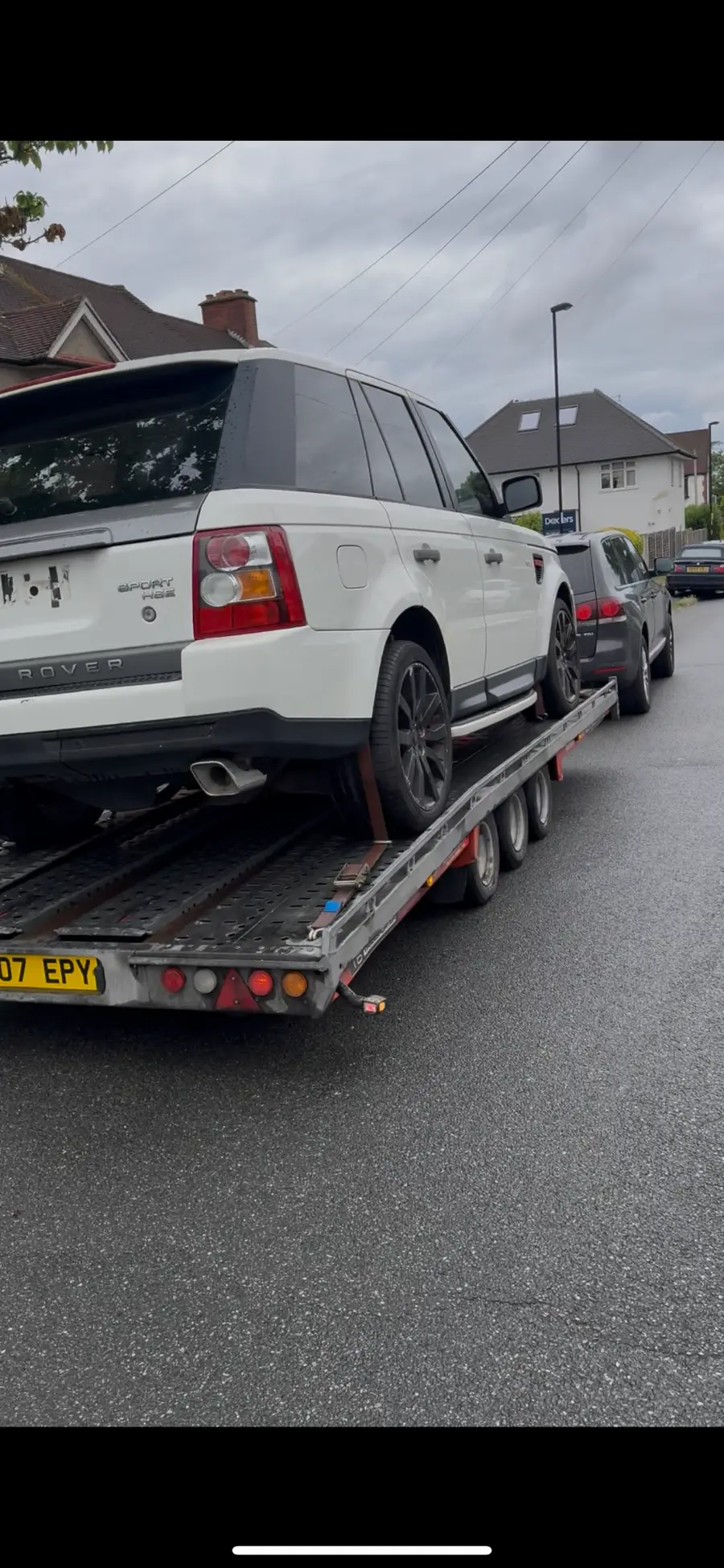 White Range Rover Sport on a recovery trailer